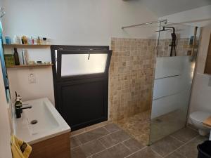 a bathroom with a shower and a black door at LA VASIO Hypercentre Vaison-la-Romaine - Air-conditioned in Vaison-la-Romaine +9 photos