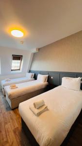 Postel nebo postele na pokoji v ubytování Mulligan Hotel