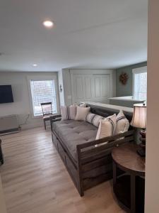 a living room with a couch and a table at Seacoast Apartment in Windham