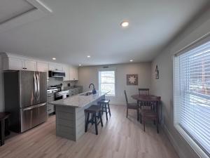 a kitchen with a counter and a table with chairs at Seacoast Apartment in Windham