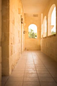 an empty hallway in a building with two windows at Ta'Filomena in Xagħra