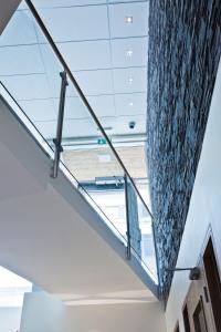 a glass staircase in a building with a glass ceiling at Hotel Klettur in Reykjavík