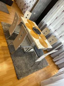a table and chairs with a watch on top of it at Marta's apartment in Shabla +20 photos
