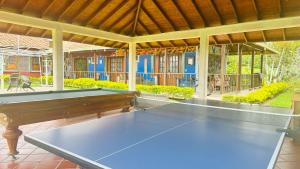 a ping pong table in the middle of a patio at Hotel Campestre Villa Nazareth in Pueblorrico