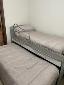 two bunk beds in a room with a mattress at Appartamento 'Diva Canova Laguna Veneta' in Santa Margherita +1 photo