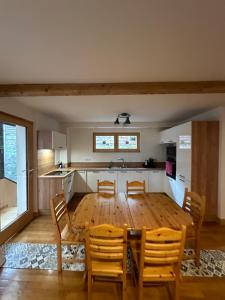 a kitchen and dining room with a table and chairs at La belle Échappée in Planay