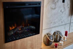 a fireplace in a living room with some food at EASY RENT Apartments- Unia Art Residence 130, Basen & SPA, Centrum Free Parking 24h Check-in in Lublin