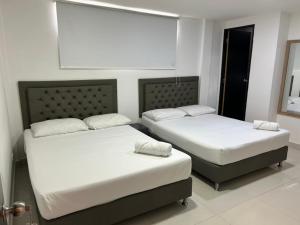Postel nebo postele na pokoji v ubytování Hotel 79 Poblado