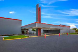 a large building with a red and white facade at OYO Hotel Orlando Airport in Orlando