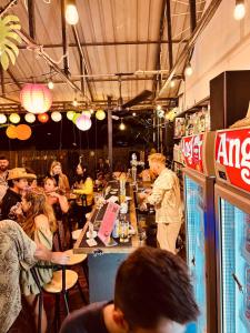 a group of people sitting at a bar in a restaurant at Good Vibes in Siem Reap +33 photos