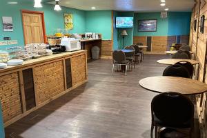 a restaurant with tables and chairs and a cafeteria at Love Hotels Kadoka by OYO at Badlands SD in Kadoka