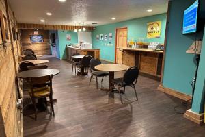 a restaurant with tables and chairs and a counter at Love Hotels Kadoka by OYO at Badlands SD in Kadoka