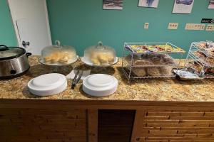 a counter with plates and bowls on top of it at Love Hotels Kadoka by OYO at Badlands SD in Kadoka