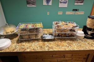 three trays of pastries on a counter in a kitchen at Love Hotels Kadoka by OYO at Badlands SD in Kadoka +37 photos