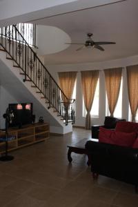 a living room with a couch and a staircase at Villa Tamaris hidden gem near beach in Jadrija