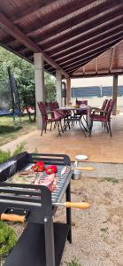 a grill with meat and vegetables on a patio at Villa Tamaris hidden gem near beach in Jadrija