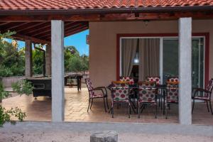 a patio with a table and chairs and a ping pong table at Villa Tamaris hidden gem near beach in Jadrija