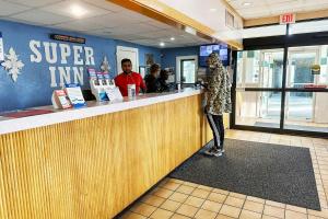 a woman standing at a counter in a super inn restaurant at Super Inn & Suites by OYO Milledgeville in Milledgeville +87 photos