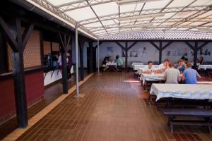 a group of people sitting at tables in a restaurant at HI Hostel Pula in Pula