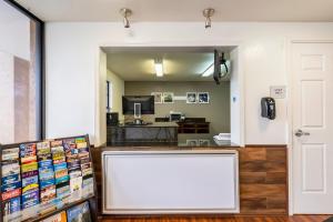 a large white screen in a room with a kitchen at OYO Hotel Bossier City LA - Red River in Bossier City
