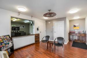 a kitchen and dining room with two chairs and a table at OYO Hotel Bossier City LA - Red River in Bossier City