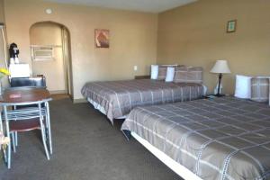 a hotel room with two beds and a desk at Love Hotels Murdo by OYO on Interstate 90 in Murdo