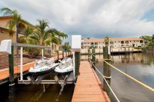 two boats docked at a dock in front of a building at OYO Waterfront Hotel- Cape Coral Fort Myers, FL in Cape Coral +33 photos
