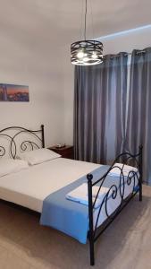 a bedroom with a bed and a chandelier at Andromeda Hideaway in Polis Chrysochous +13 photos