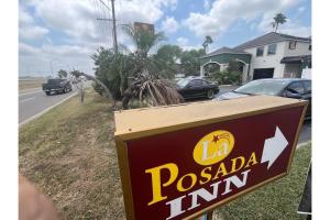 a sign for a pascale timm on the side of a road at La Posada Inn By OYO Brownsville in Brownsville +39 photos