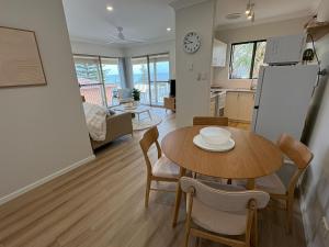a kitchen and living room with a table and chairs at Bunbury Ocean Views in Bunbury