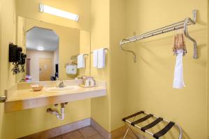 a bathroom with a sink and a mirror at OYO Hotel Valley View TX, I-35 in Valley View