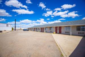 a building with a car parked in a parking lot at Holiday Motel By OYO Lordsburg I-10 in Lordsburg