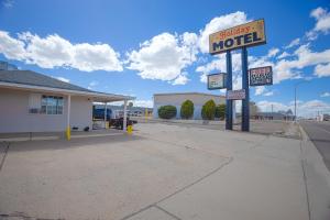 a motel sign on the side of a road at Holiday Motel By OYO Lordsburg I-10 in Lordsburg