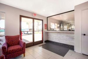 a waiting room with a chair and a mirror at Hotel Palmdale - Antelope Valley in Palmdale +16 photos