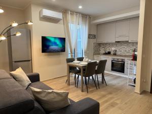 a living room with a couch and a table with chairs at SeaLaVie in Savona