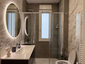 a bathroom with a sink and a toilet and a mirror at SeaLaVie in Savona