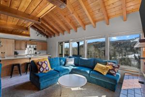 a living room with a blue couch and a table at 10A Condo Chalet Village Brian Head UT in Brian Head +31 photos