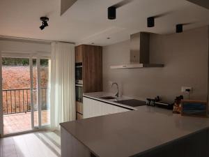 a kitchen with a counter and a view of a balcony at Moderno apartamento en La Manga Club in Atamaría