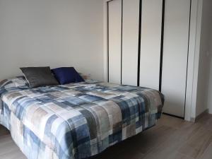 a bedroom with a bed with a plaid blanket at Moderno apartamento en La Manga Club in Atamaría +7 photos