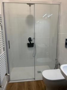 a bathroom with a shower with a toilet and a sink at Pirandello 181 in Palermo