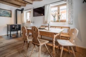a dining room with a wooden table and chairs at Weidenchalets in Sellrain
