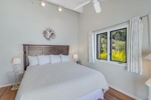 a white bedroom with a bed and two windows at H180 - Hamilton Cove Villa 1-80 in Avalon +44 photos