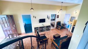 a living room with a couch and a television at Away From Home - 1 - Rooms In Ooty, Home Stay Ooty in Ooty +27 photos