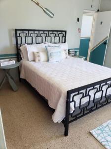 a bedroom with a black and white bed and a table at Kassa Wista Azzul Rentals-with pool in Hormigueros