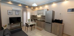 a kitchen with a refrigerator and a small table at Xenia_Apartments A6 in Kozani