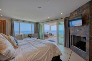 a bedroom with a bed with a fireplace and a television at H208 - The Honeymoon Penthouse Suite Palazzo De Mare in Avalon