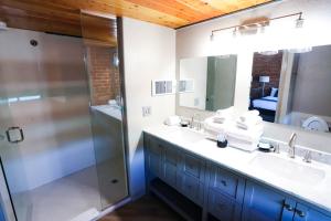 a bathroom with a double sink and a shower at The Hotel Sturgis in Sturgis +68 photos