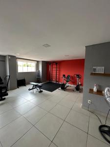 a large room with a gym with a large white tile floor at Melhor cidade do Brasil! Melhor apto. do Brasil! in Sorocaba