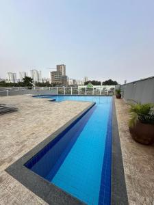 a swimming pool with blue tiles on the side of a building at Melhor cidade do Brasil! Melhor apto. do Brasil! in Sorocaba