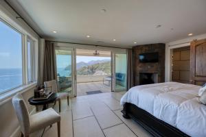 a bedroom with a bed and a view of the ocean at H208 - The Honeymoon Penthouse Suite Palazzo De Mare in Avalon +51 photos